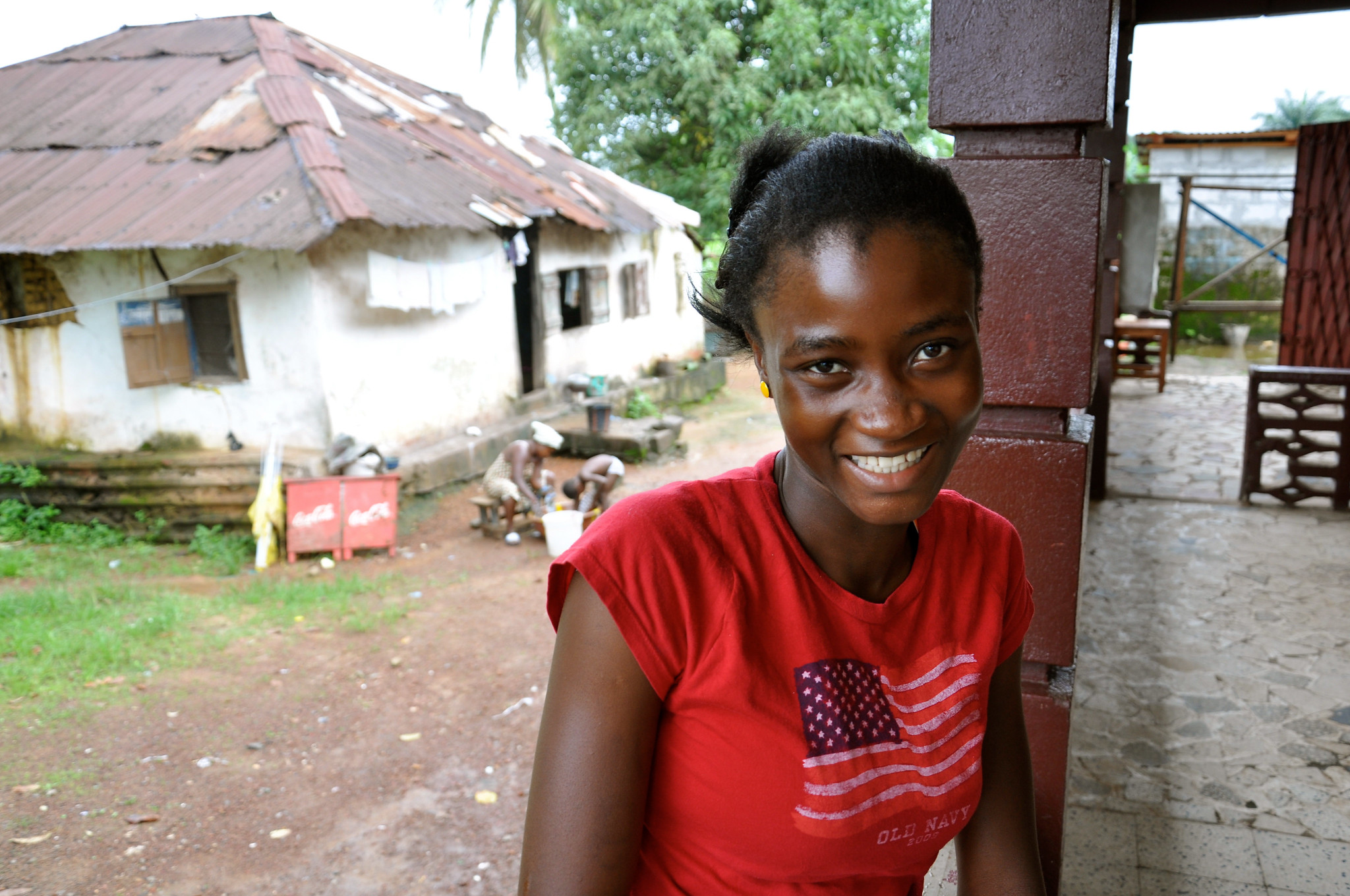 An Advancing Youth Project beneficiary takes a break outside of her classroom. The USAID Advancing Youth Project provides increased access to quality alternative basic education services, social and leadership development and livelihoods for out of school youth aged 13-35 who have no or marginal literacy and numeracy skills. Grand Bassa, Liberia.